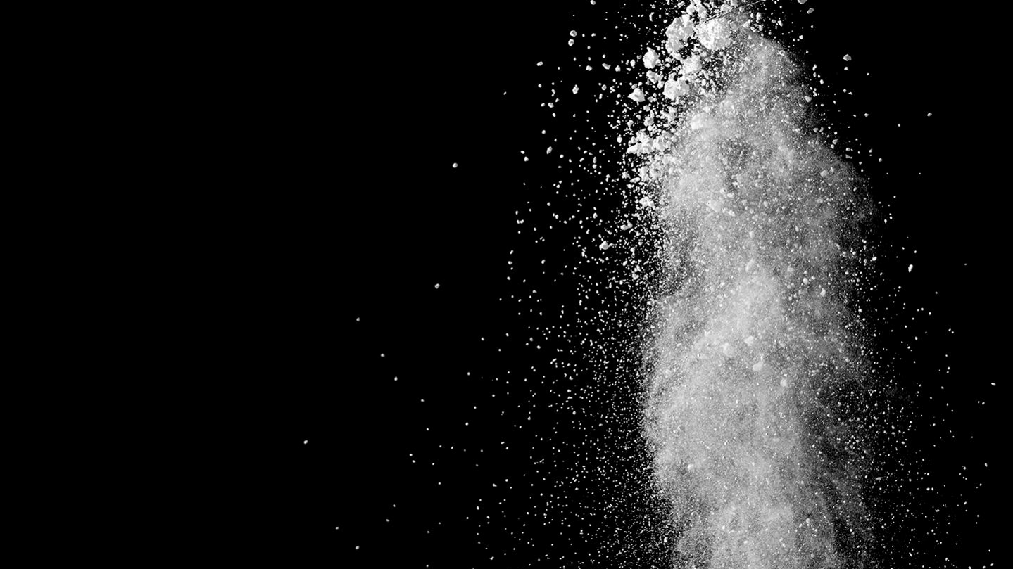 White powder splatter on black background