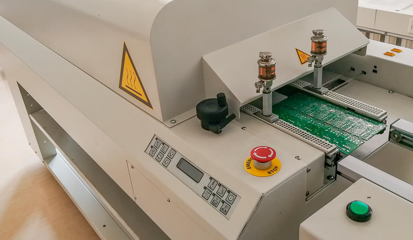 Printed circuit board after full assembly moves to reflow oven machine for heating up soldering pas