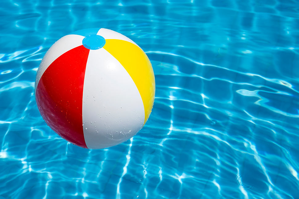 A beach ball floating in a blue pool